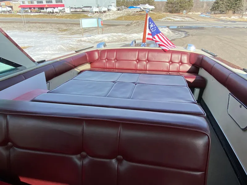 Slide: The Image of 1968 Century Coronado boat with red leather seating and American flag. - 10