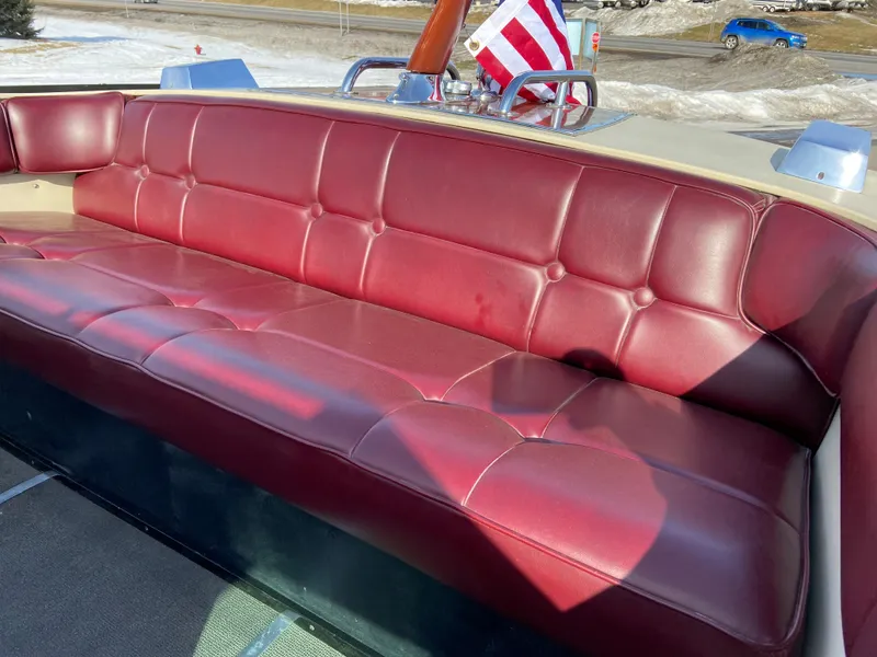Slide: The Image of 1968 Century Coronado boat with red leather seating and American flag in the background. - 12