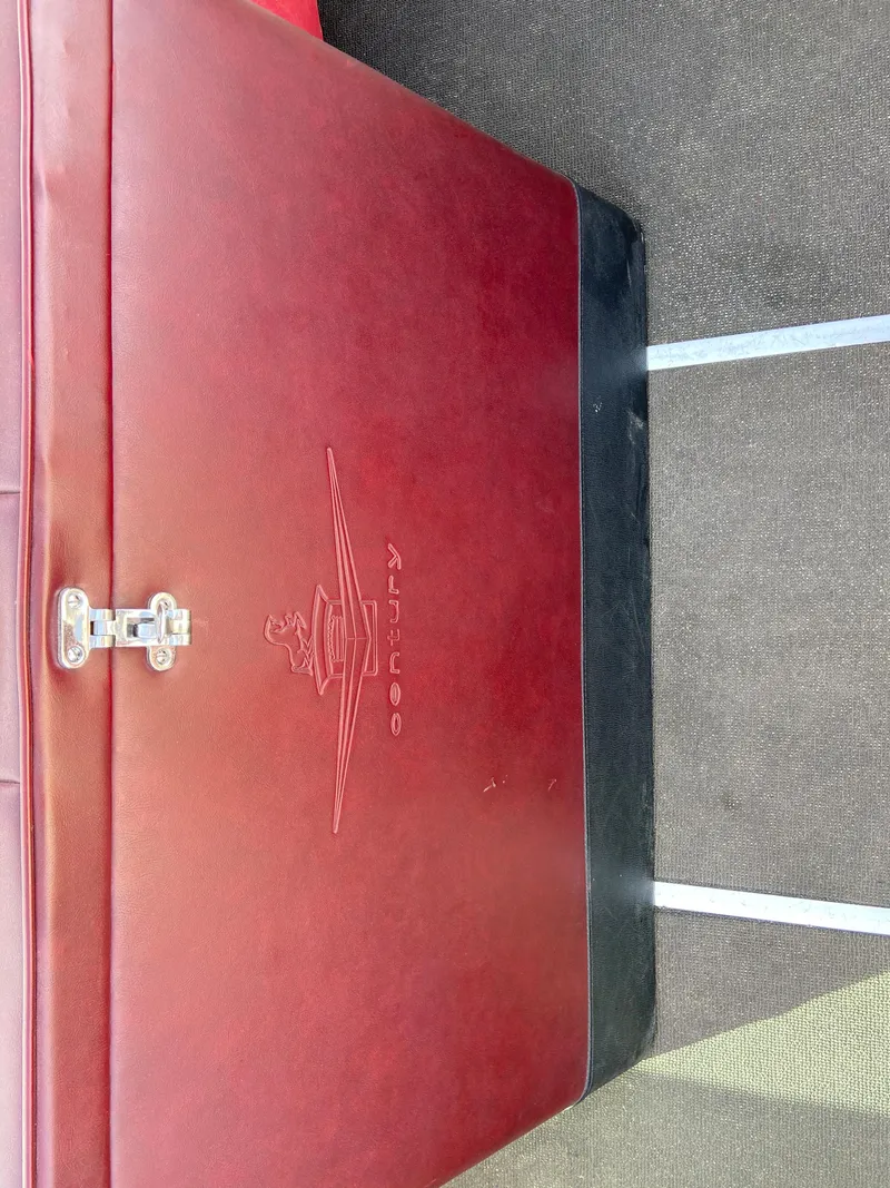 Slide: The Image of 1968 Century Coronado red leather interior detail with embossed logo and metal latch. - 13