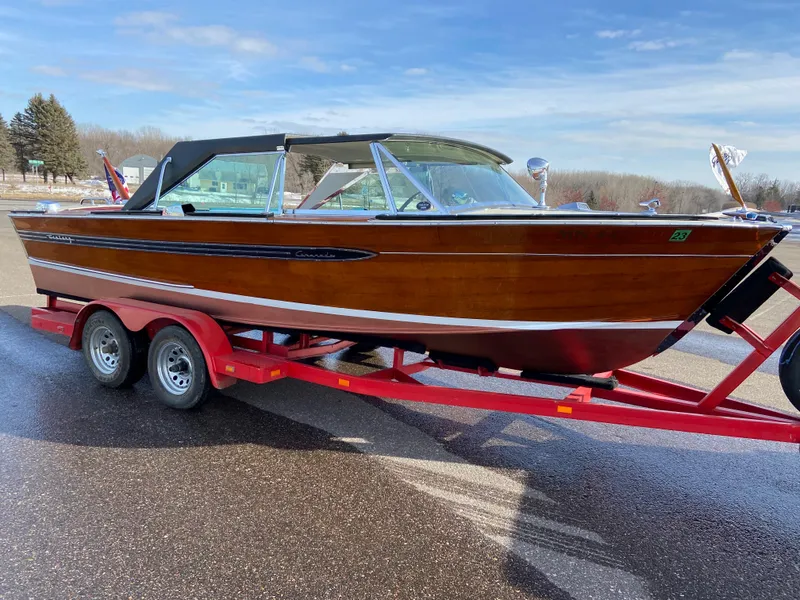 Slide: The Image of 1968 Century Coronado boat on red trailer, showcasing classic wooden design and sleek lines. - 2