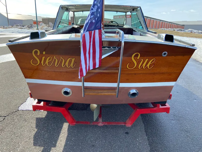 Slide: The Image of 1968 Century Coronado boat named "Sierra Sue" with American flag on a trailer. - 4