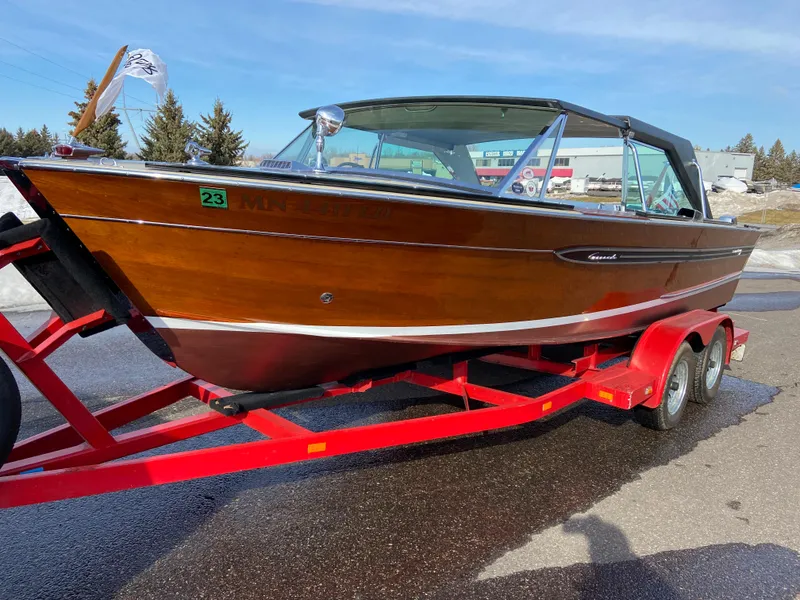 Slide: The Image of 1968 Century Coronado boat on red trailer, showcasing classic wooden design. - 6