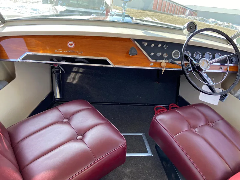 Slide: The Image of 1968 Century Coronado boat interior with red leather seats and classic wooden dashboard. - 9