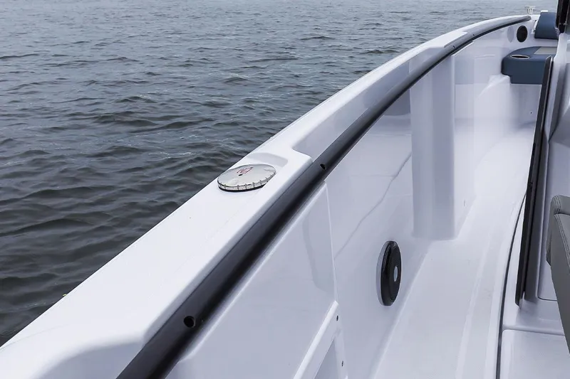 Slide: The Image of 2022 Axopar 22 T-Top boat deck close-up on water. - 11