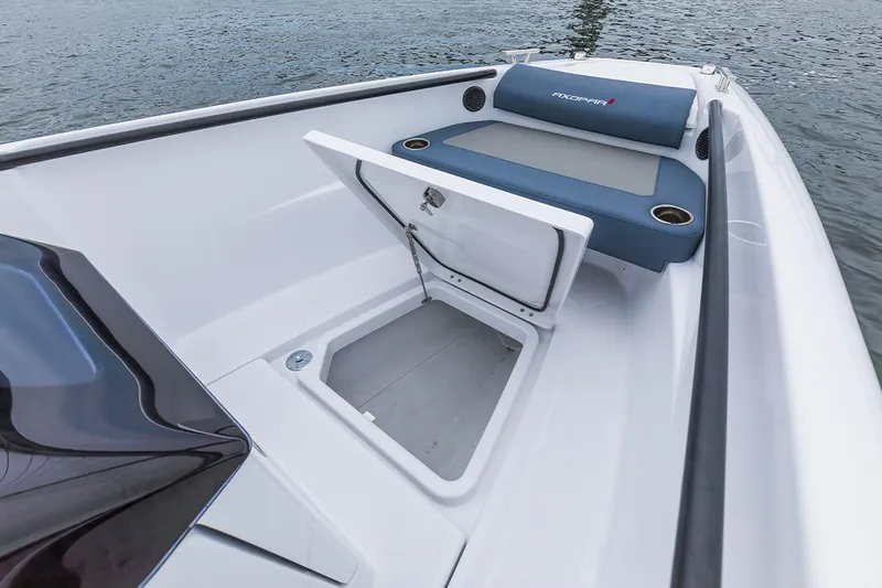 Slide: The Image of 2022 Axopar 22 T-Top boat with open storage compartment and seating area. - 13