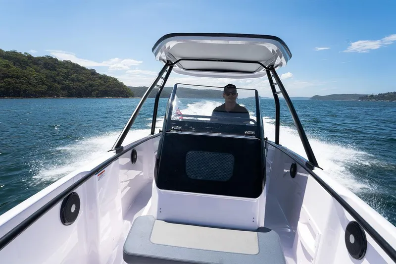 Slide: The Image of 2022 Axopar 22 T-Top boat cruising on a sunny day. - 14