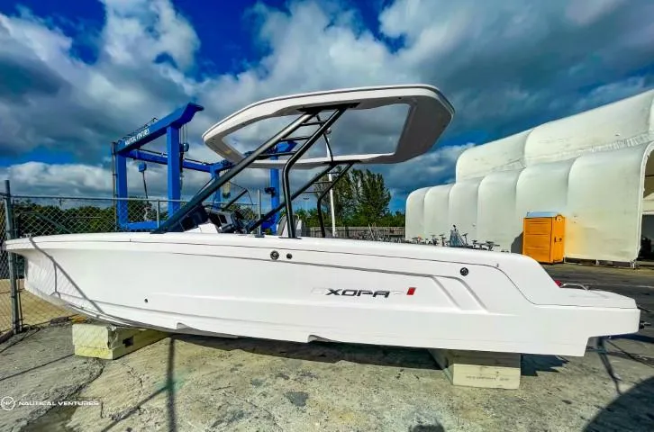 Slide: The Image of 2022 Axopar 22 T-Top boat on display under a partly cloudy sky. - 4
