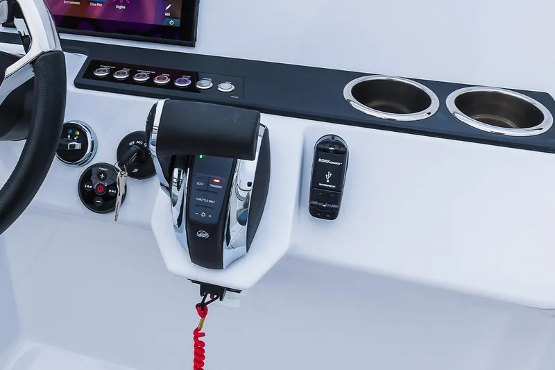 Slide: The Image of Control panel of 2022 Axopar 22 T-Top boat with throttle and cup holders. - 9
