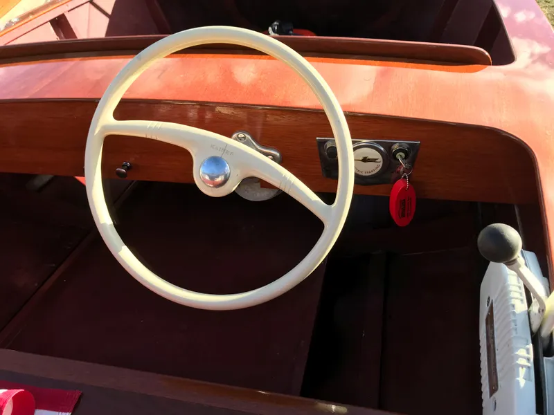 Slide: The Image of 1954 Chris-Craft kit boat steering wheel and dashboard, featuring classic wooden design and vintage controls. - 4