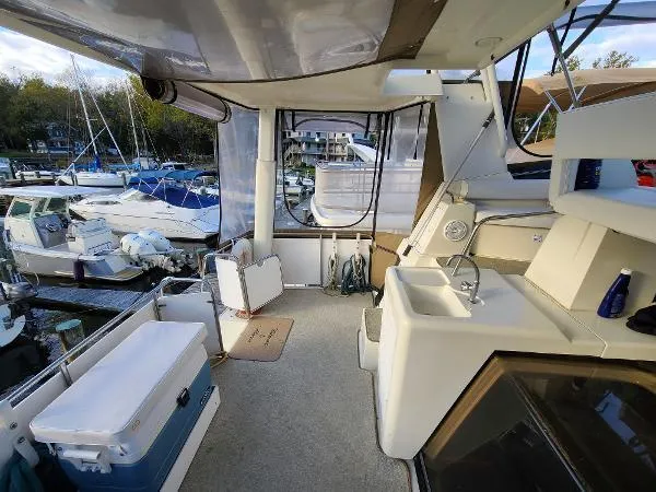 Slide: The Image of 1995 Silverton 34 Aft Cabin Motor Yacht interior with sink and marina view. - 11