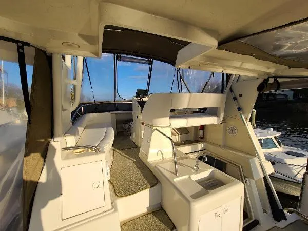 Slide: The Image of 1995 Silverton 34 Aft Cabin Motor Yacht interior with seating and helm station. - 12