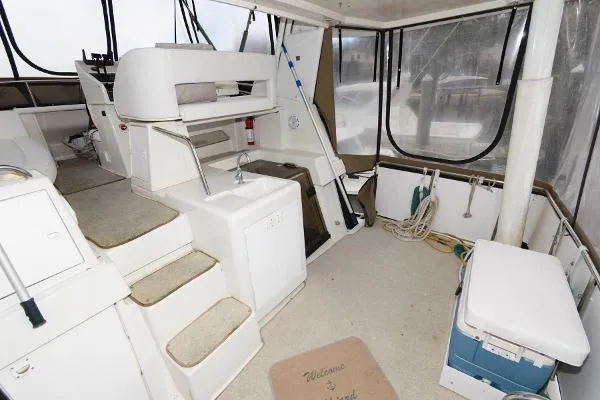 Slide: The Image of 1995 Silverton 34 Aft Cabin Motor Yacht interior with helm, seating, and storage. - 16