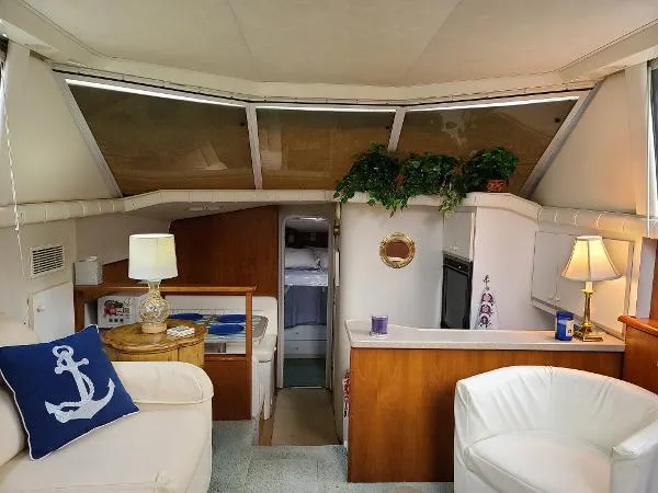 Slide: The Image of Interior of 1995 Silverton 34 Aft Cabin Motor Yacht with cozy seating and nautical decor. - 19