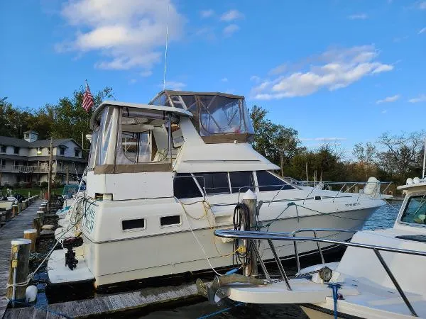 Slide: The Image of 1995 Silverton 34 Aft Cabin Motor Yacht docked at marina. - 2