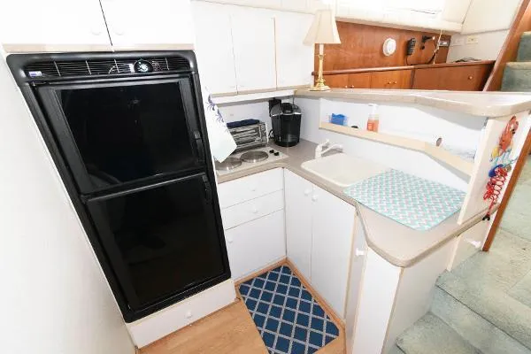 Slide: The Image of Compact kitchen area in a 1995 Silverton 34 Aft Cabin Motor Yacht. - 22