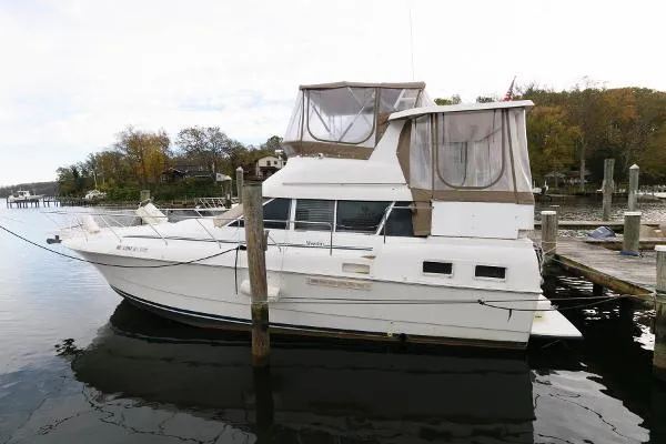 Slide: The Image of 1995 Silverton 34 Aft Cabin Motor Yacht docked at a marina. - 3