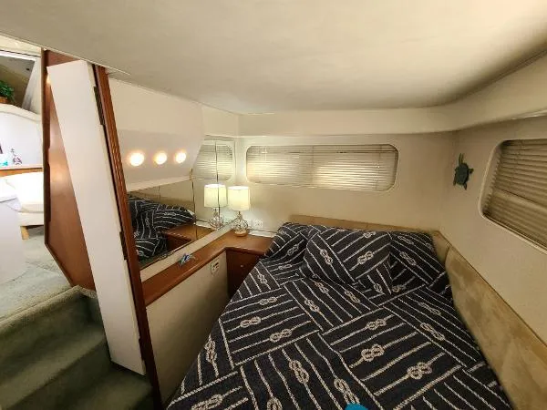 Slide: The Image of 1995 Silverton 34 Aft Cabin Motor Yacht bedroom with nautical-themed bedding. - 30
