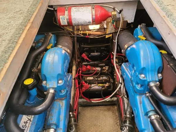 Slide: The Image of 1995 Silverton 34 Aft Cabin Motor Yacht engine room with blue engines and fire extinguisher. - 31