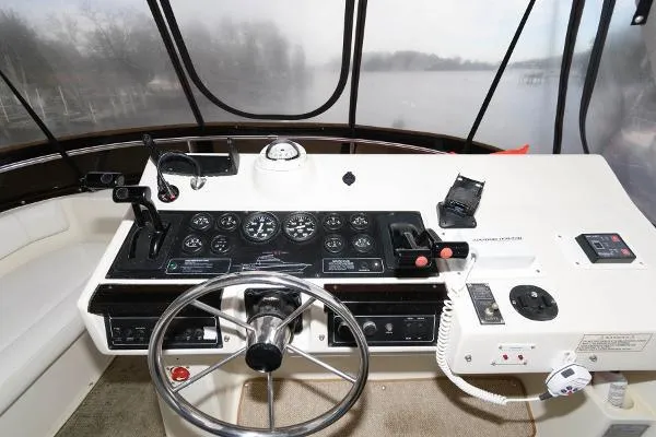 Slide: The Image of Helm of 1995 Silverton 34 Aft Cabin Motor Yacht with steering wheel and control panel. - 8