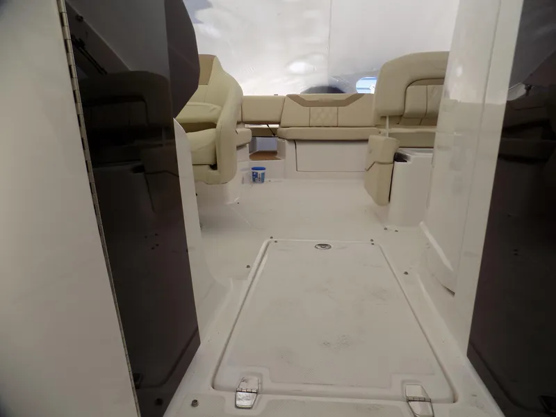 Slide: The Image of 2019 Regal 23obx boat interior with beige seating and storage compartments. - 10