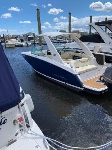 Slide: The Image of 2019 Regal 23obx boat docked in a marina under a clear blue sky. - 12