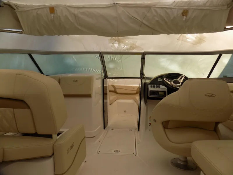 Slide: The Image of 2019 Regal 23obx boat interior with beige seating and steering console. - 4