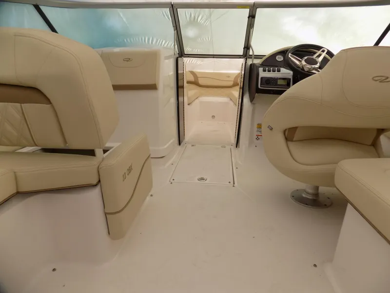 Slide: The Image of 2019 Regal 23obx boat interior with beige seating and steering console. - 5