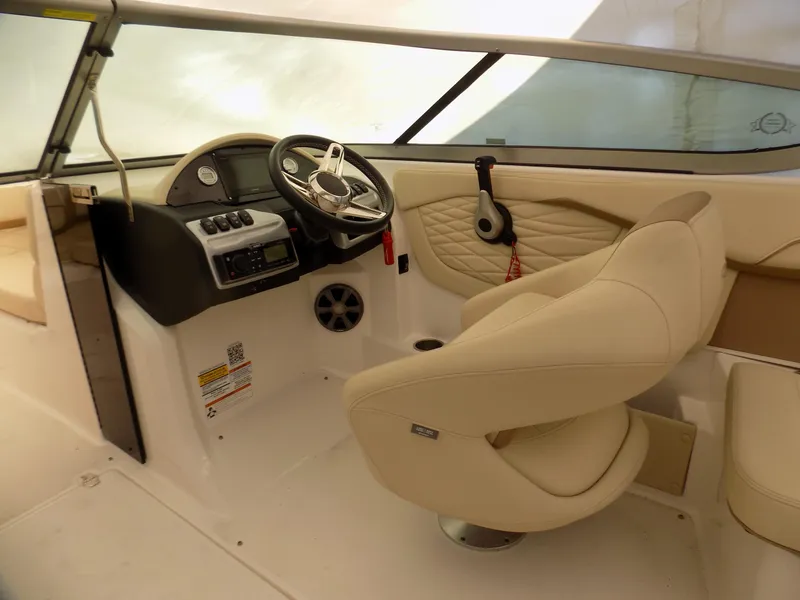 Slide: The Image of 2019 Regal 23obx boat interior with steering wheel and beige seating. - 6