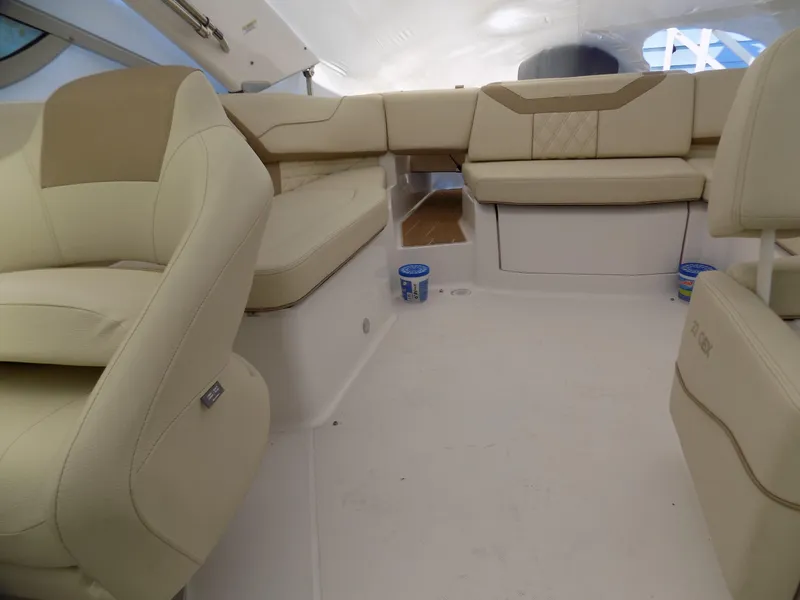 Slide: The Image of 2019 Regal 23obx boat interior with beige seating and spacious layout. - 7