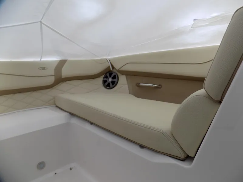 Slide: The Image of 2019 Regal 23obx boat interior with beige seating and speaker. - 9