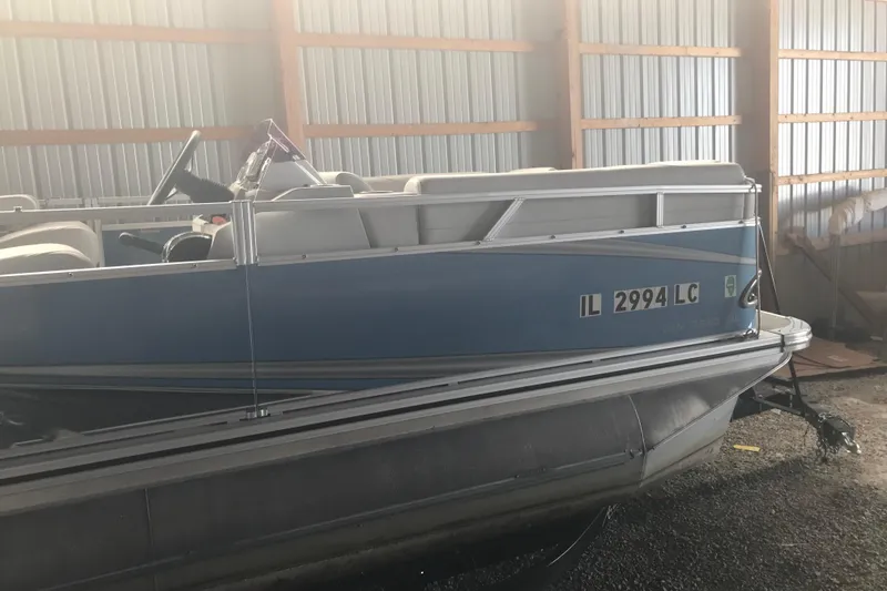Slide: The Image of 2022 Avalon VENTURE QUAD LOUNGE pontoon boat in storage, side view. - 10