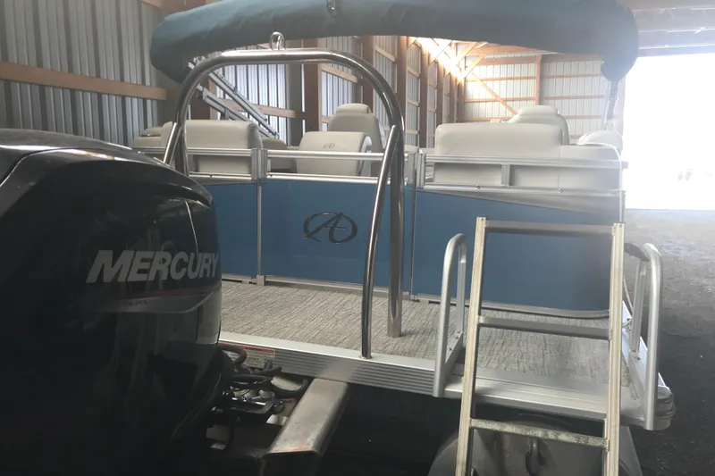 Slide: The Image of 2022 Avalon VENTURE QUAD LOUNGE pontoon boat with Mercury engine in a storage facility. - 13