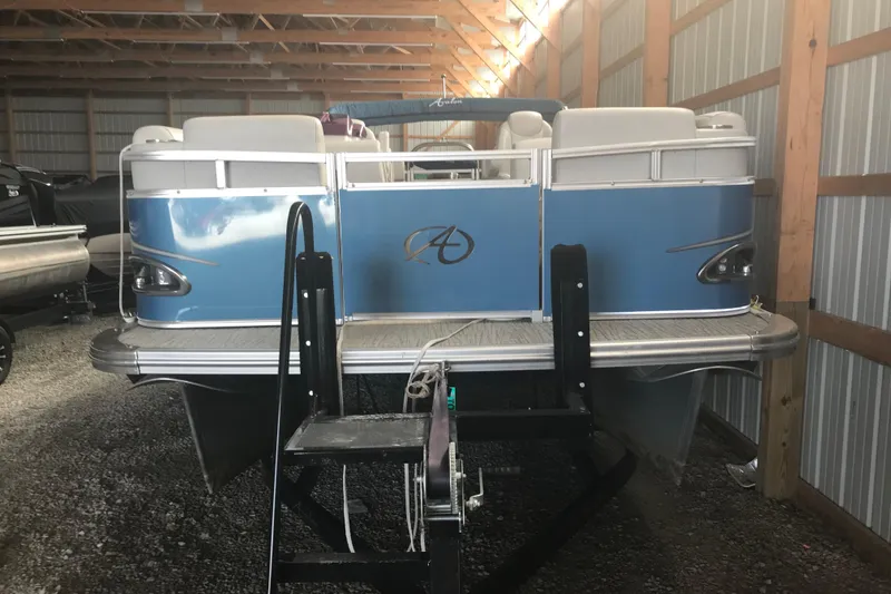 Slide: The Image of 2022 Avalon VENTURE QUAD LOUNGE pontoon boat in storage, rear view. - 14