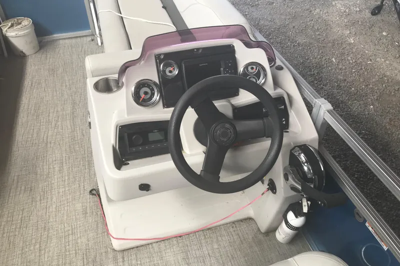 Slide: The Image of 2022 Avalon VENTURE QUAD LOUNGE boat dashboard with steering wheel and controls. - 19
