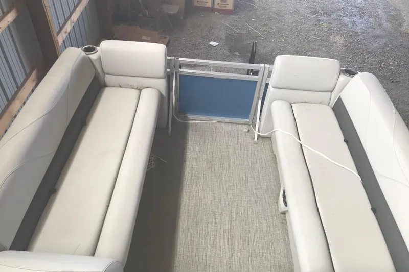 Slide: The Image of 2022 Avalon VENTURE QUAD LOUNGE interior with white seating in a storage area. - 21