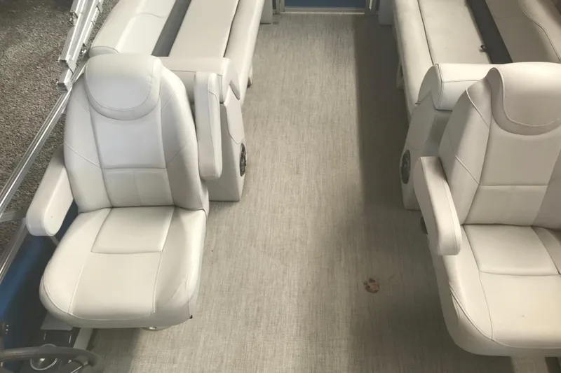 Slide: The Image of 2022 Avalon VENTURE QUAD LOUNGE interior with white seating and spacious layout. - 22