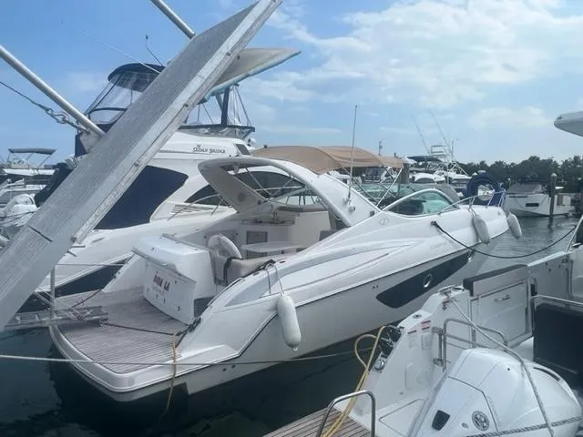 Slide: The Image of 2018 Schaefer 365 yacht docked at a marina under a partly cloudy sky. - 0