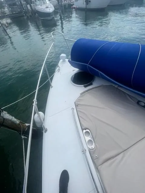 Slide: The Image of 2018 Schaefer 365 yacht docked, featuring a sleek deck and blue sail cover. - 17