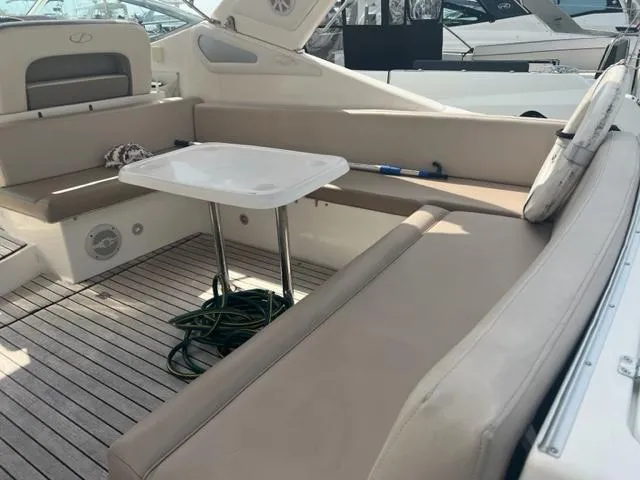 Slide: The Image of 2018 Schaefer 365 yacht interior with beige seating and table on deck. - 22