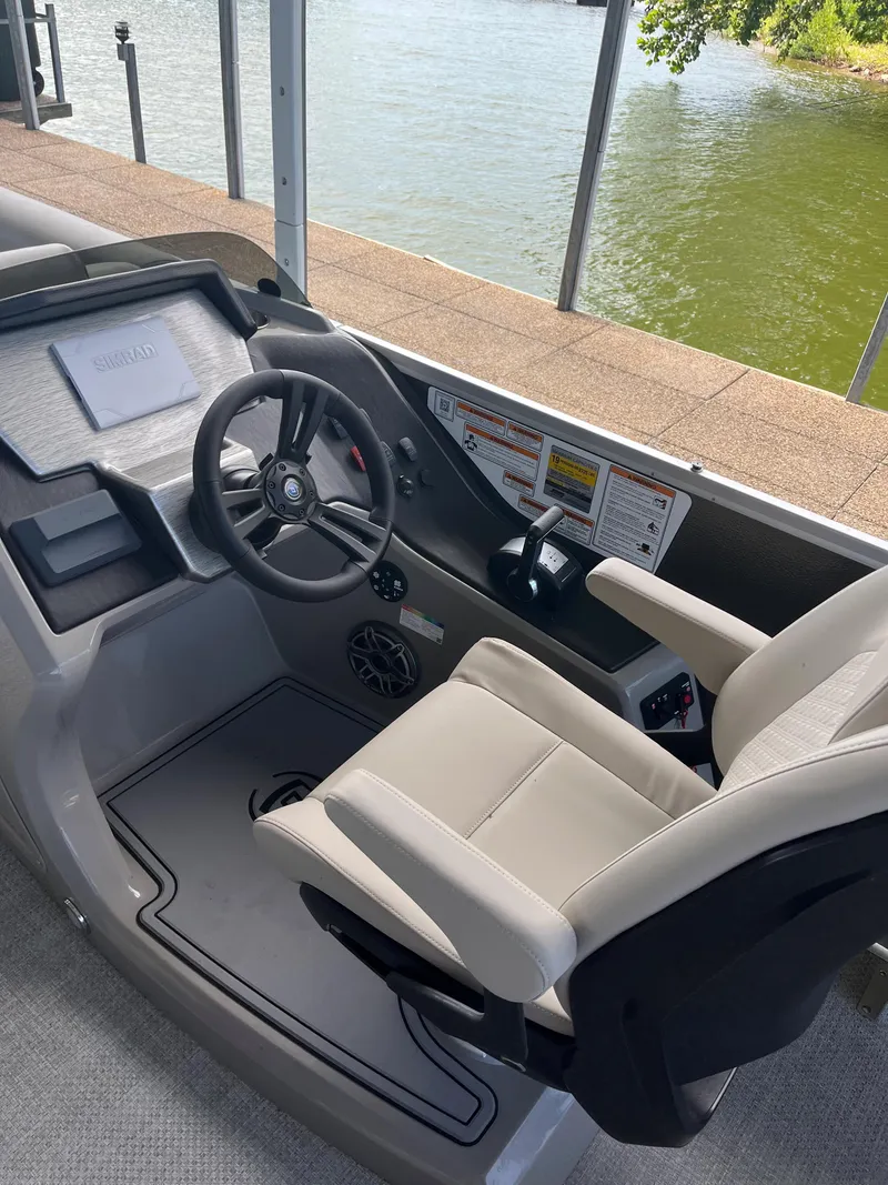 Slide: The Image of 2022 Premier 250 SunSation RL boat cockpit with steering wheel and control panel. - 2