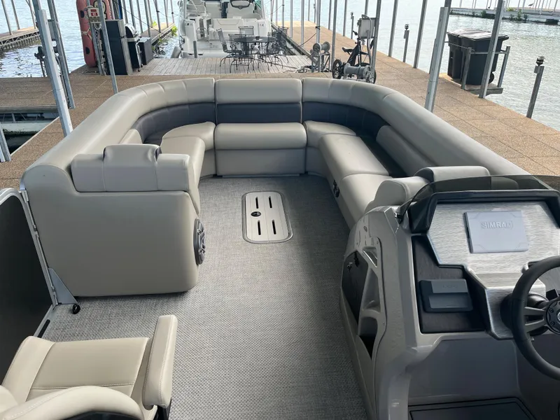 Slide: The Image of 2022 Premier 250 SunSation RL pontoon boat interior with spacious seating and modern helm. - 3