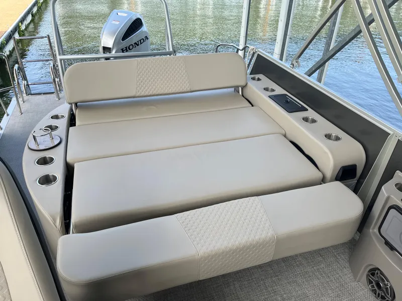Slide: The Image of 2022 Premier 250 SunSation RL boat with spacious seating and Honda outboard motor. - 6
