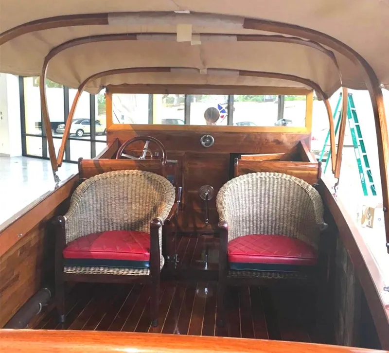 Slide: The Image of 2004 Custom 28 Rum Runner boat interior with wicker chairs and wooden finish. - 12