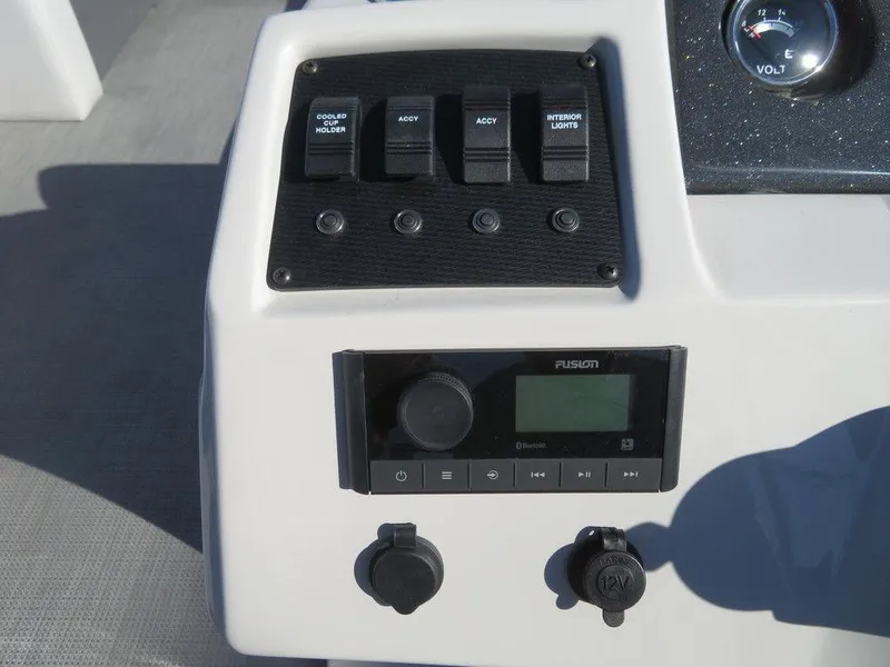 Slide: The Image of Control panel of 2022 Crest Classic Fish 200 SF boat with switches and Fusion stereo. - 13