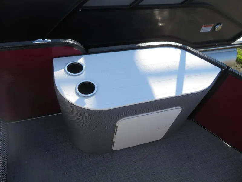 Slide: The Image of 2022 Crest Classic Fish 200 SF boat interior with cup holders and storage compartment. - 15