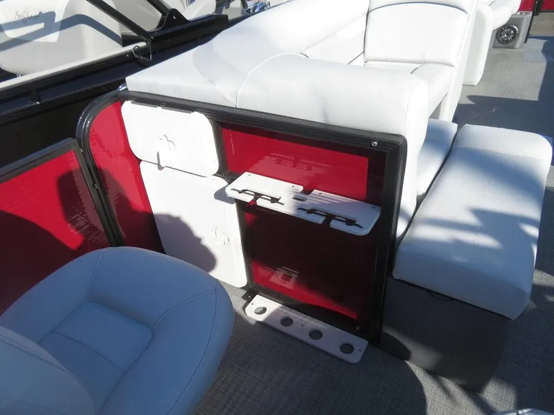 Slide: The Image of 2022 Crest Classic Fish 200 SF boat interior with white seating and red storage compartments. - 18