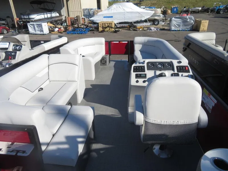Slide: The Image of 2022 Crest Classic Fish 200 SF pontoon boat interior with white seating and control console. - 21