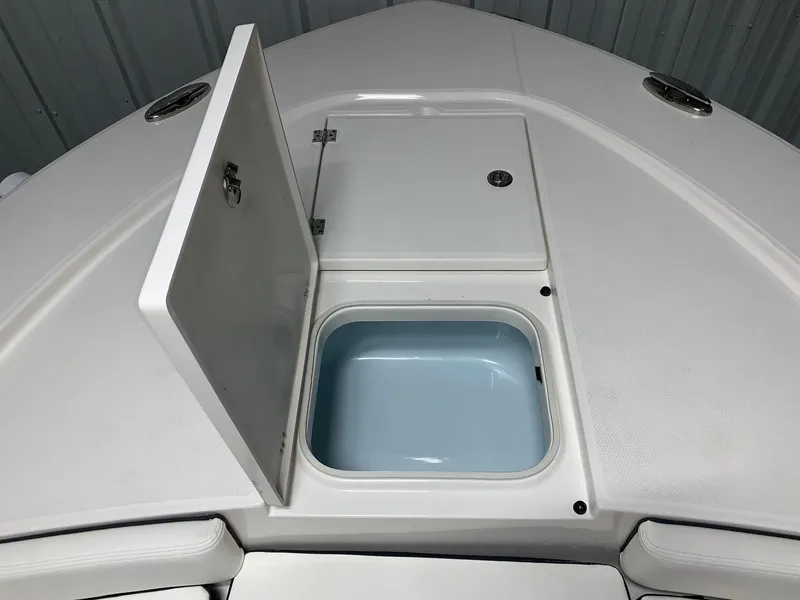 Slide: The Image of 2024 Robalo 246 Cayman boat with open storage compartment. - 10
