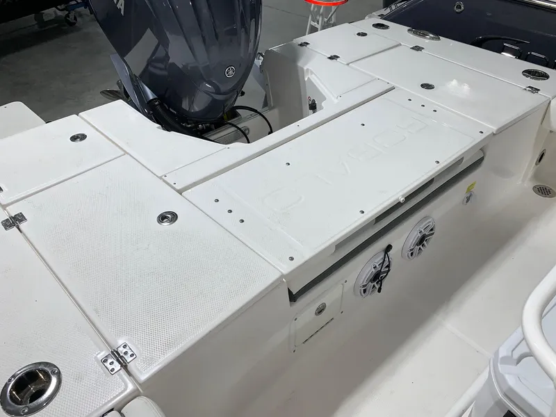 Slide: The Image of 2024 Robalo 246 Cayman boat deck with storage compartments and outboard motor. - 4