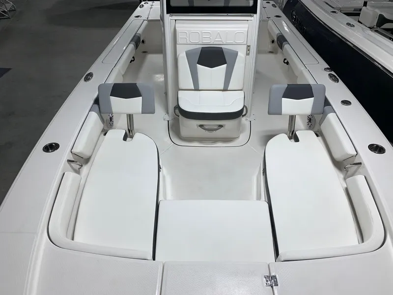 Slide: The Image of 2024 Robalo 246 Cayman boat interior with white and gray seating. - 11